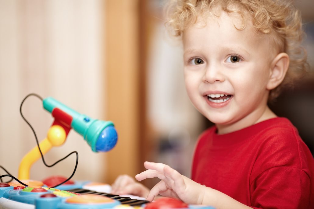 little boy playing with a toy microphone